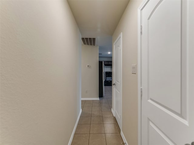 hallway with light tile patterned floors