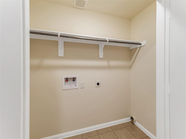 laundry area with hookup for a washing machine, hookup for an electric dryer, and light tile patterned floors