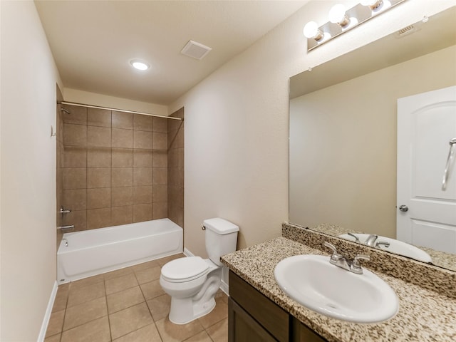 full bathroom with tiled shower / bath, vanity, toilet, and tile patterned floors