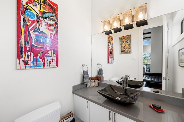 bathroom featuring vanity and toilet