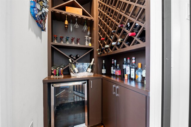 wine area featuring wine cooler and bar