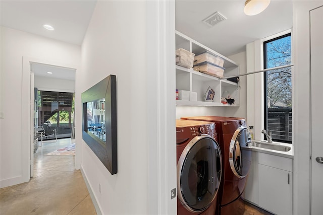 laundry room featuring washer and clothes dryer and sink