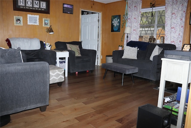 living room featuring hardwood / wood-style flooring and wood walls