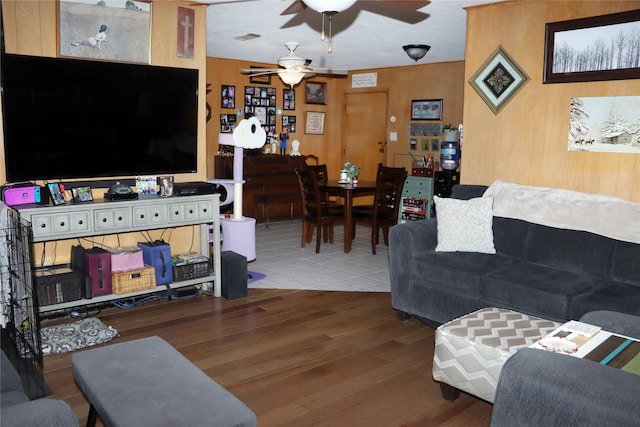 living room with hardwood / wood-style floors and ceiling fan