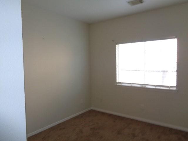 empty room with dark carpet