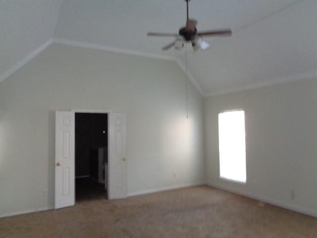 empty room featuring ceiling fan, carpet flooring, and vaulted ceiling