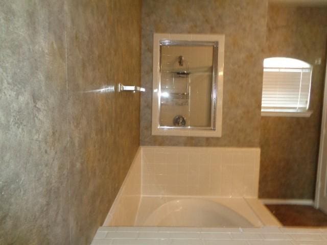 bathroom featuring plus walk in shower