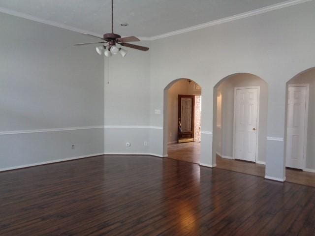 unfurnished room with crown molding, dark wood-type flooring, and ceiling fan