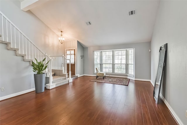 interior space with dark wood-type flooring, high vaulted ceiling, and a chandelier