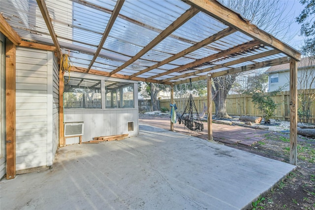 view of patio / terrace with a wall mounted AC, a pergola, and a sunroom