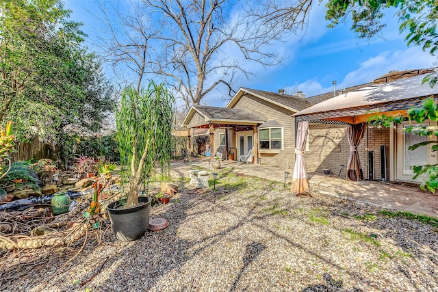 rear view of house with a gazebo and a patio