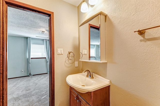 bathroom with vanity and a textured ceiling