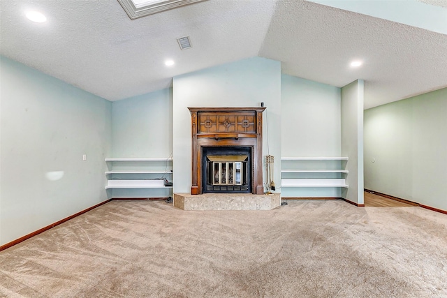 unfurnished living room featuring light colored carpet, lofted ceiling, and a textured ceiling