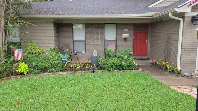 doorway to property featuring a yard