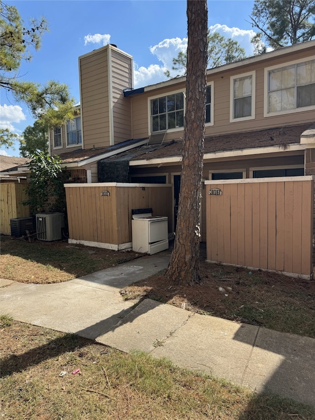 exterior space with a garage and central AC unit