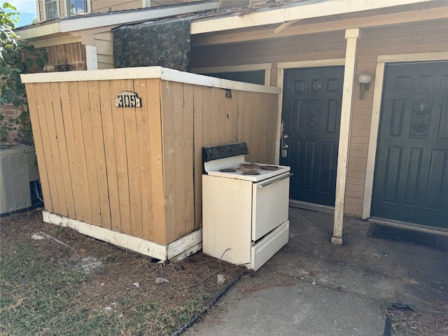 exterior details featuring white electric stove and central AC unit