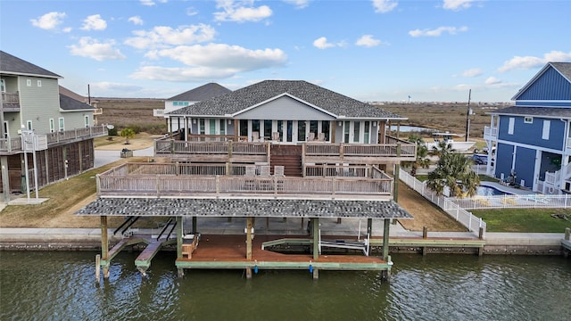 dock area with a water view and a balcony