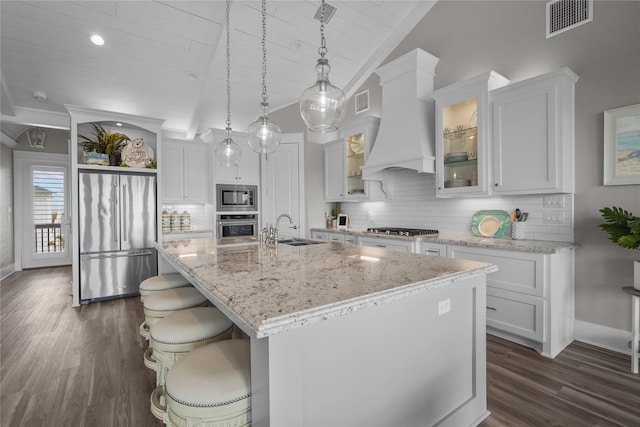 kitchen with a kitchen island with sink, sink, white cabinetry, and stainless steel appliances