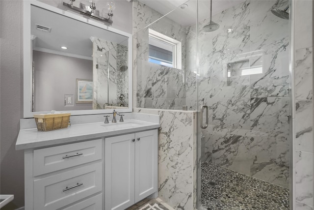 bathroom featuring vanity, crown molding, and a shower with shower door