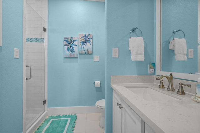 bathroom with vanity, tile patterned floors, a shower with door, and toilet