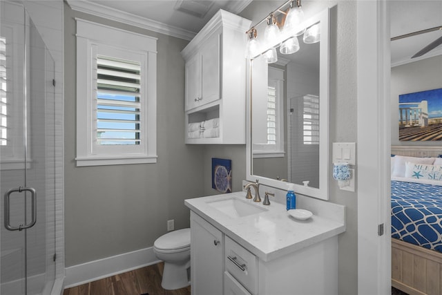 bathroom featuring hardwood / wood-style floors, ornamental molding, vanity, an enclosed shower, and toilet