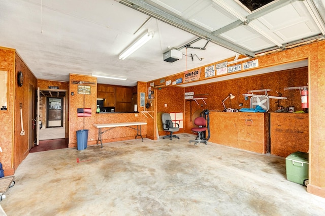 garage featuring a garage door opener and a workshop area