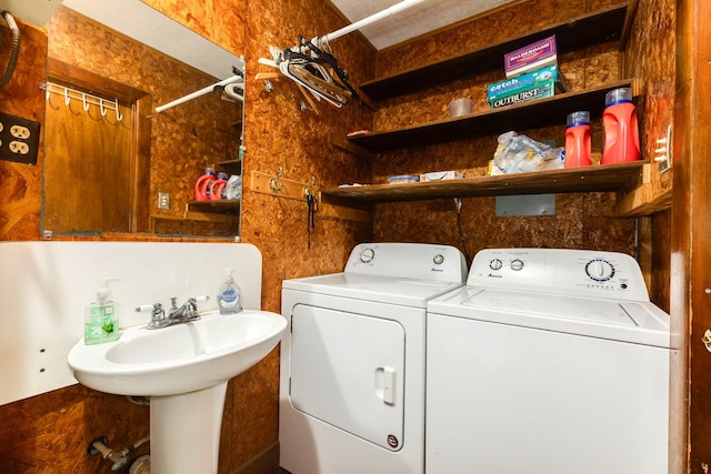 clothes washing area featuring separate washer and dryer