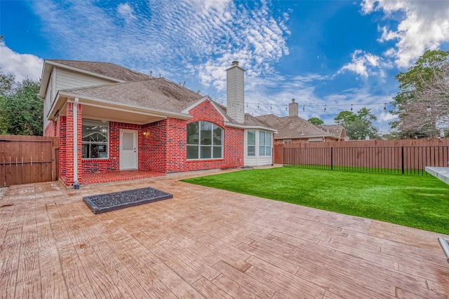 back of property featuring a patio area and a lawn