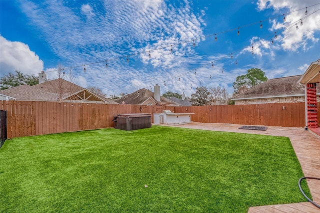 view of yard featuring a hot tub, a fire pit, and a patio area