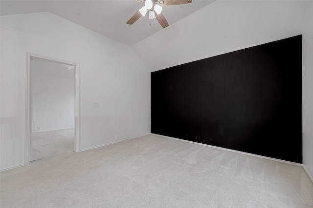 carpeted spare room with lofted ceiling and ceiling fan