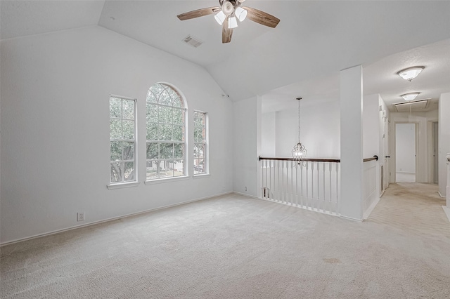 carpeted empty room featuring lofted ceiling and ceiling fan