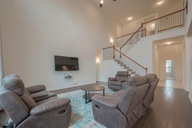 living room with hardwood / wood-style flooring and a high ceiling