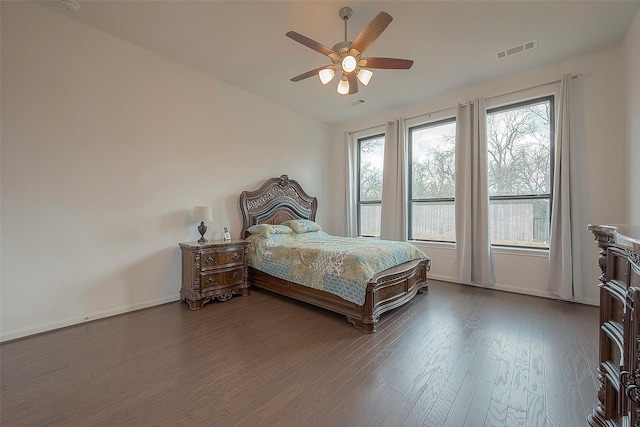 bedroom featuring multiple windows, hardwood / wood-style floors, vaulted ceiling, and ceiling fan