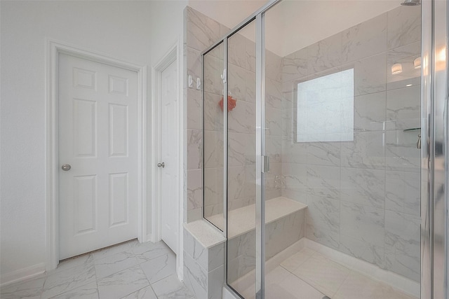 bathroom featuring a shower with door