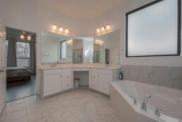 bathroom featuring vanity and independent shower and bath