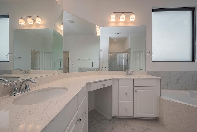 bathroom featuring vanity and separate shower and tub