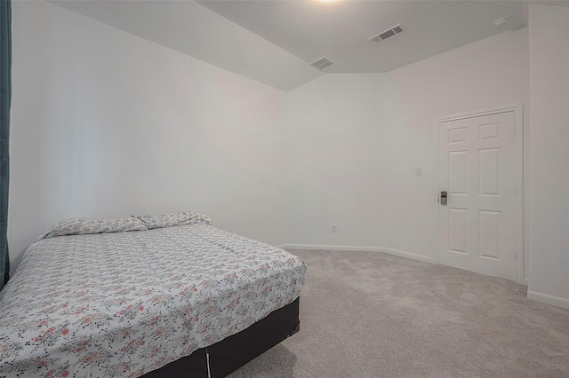 bedroom with carpet flooring and vaulted ceiling