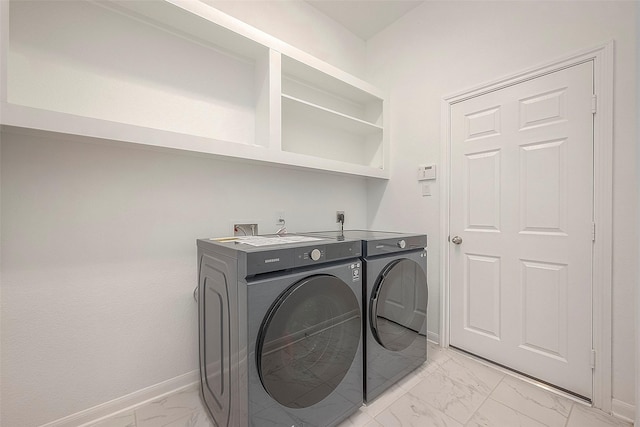 clothes washing area featuring separate washer and dryer