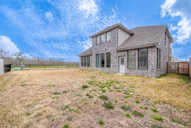 rear view of house with a lawn