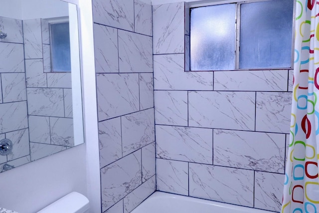 bathroom with shower / tub combo and toilet