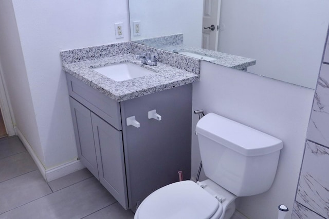 bathroom with vanity, toilet, and tile patterned flooring