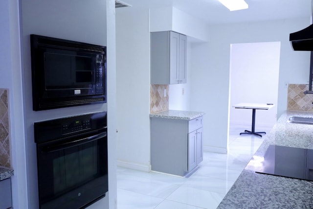 kitchen with tasteful backsplash, range hood, gray cabinets, and black appliances