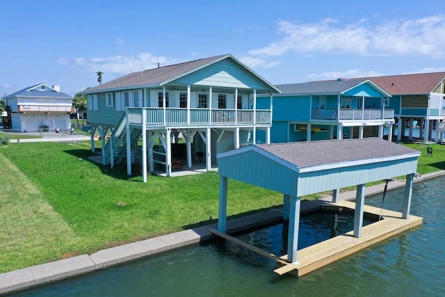 back of property featuring a water view and a yard