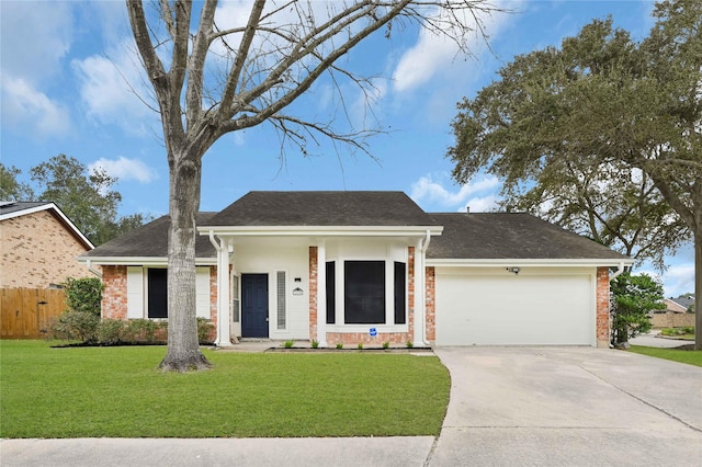 view of front of property with a garage and a front lawn