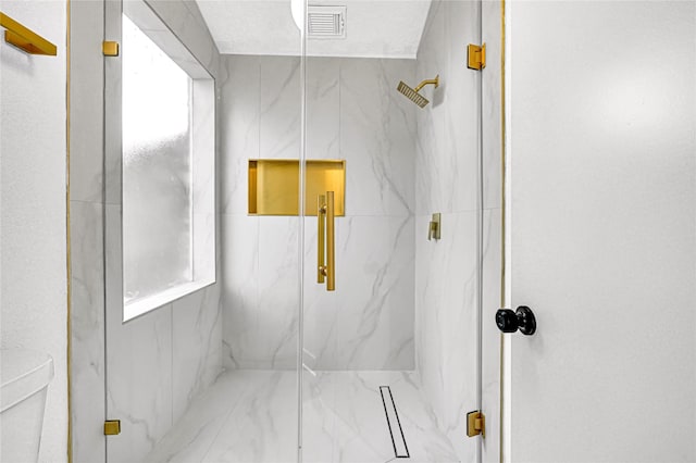 bathroom featuring a shower with shower door