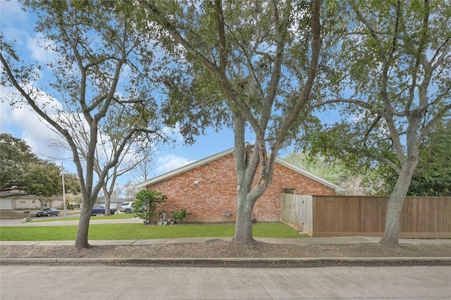 view of side of home featuring a yard