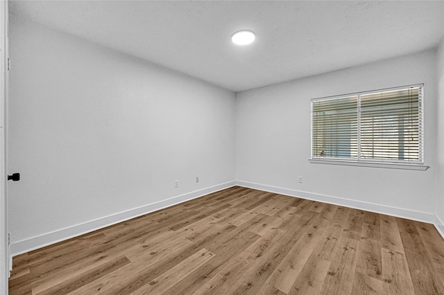 spare room featuring light hardwood / wood-style floors