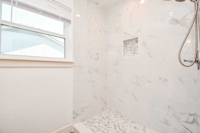 bathroom with a tile shower