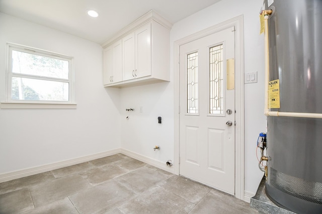 laundry room with water heater and cabinets