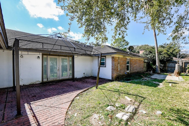 back of house with a yard and a patio area